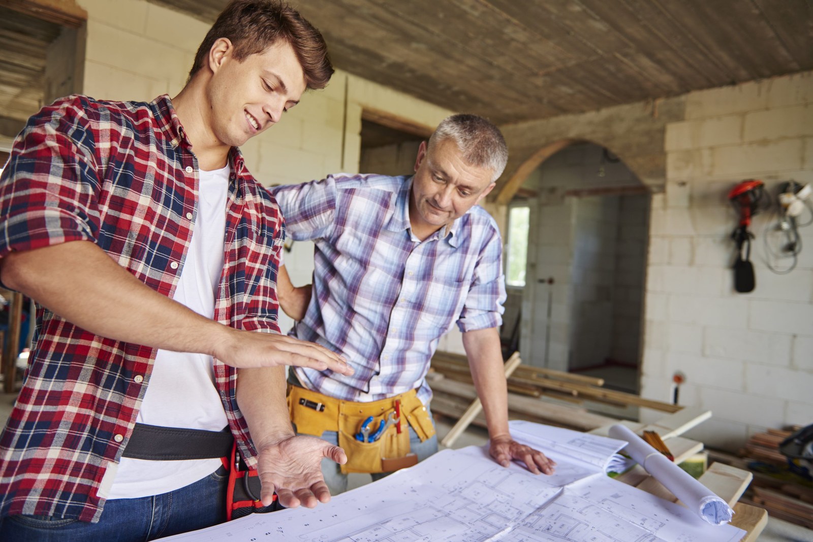 Two builders reviewing plans together on a Dwellings project
